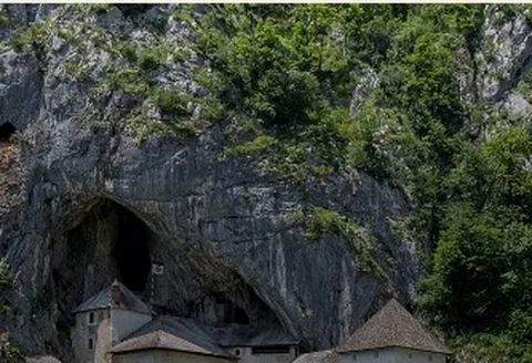 The castle built into a cave mouth in the cliff