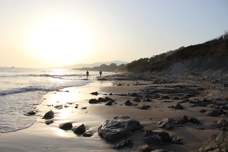 Sunset over the wide sand and rocks of the Playa de los Lances at Tarifa