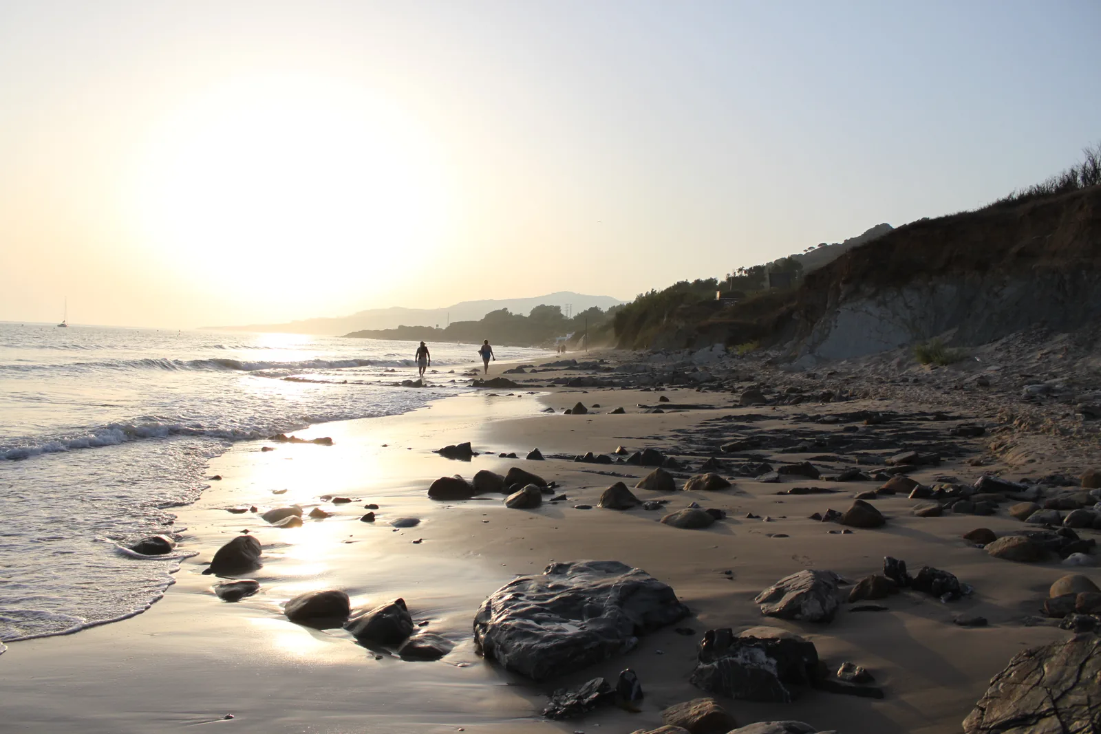 Sunset over the wide sand and rocks of the Playa de los Lances at Tarifa